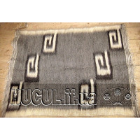 The "Curls" blanket is black and white, handmade.