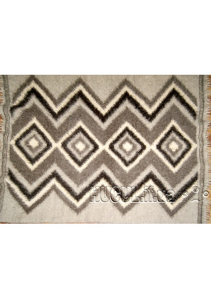 The "Hromovytsia" blanket is black and white, handmade.