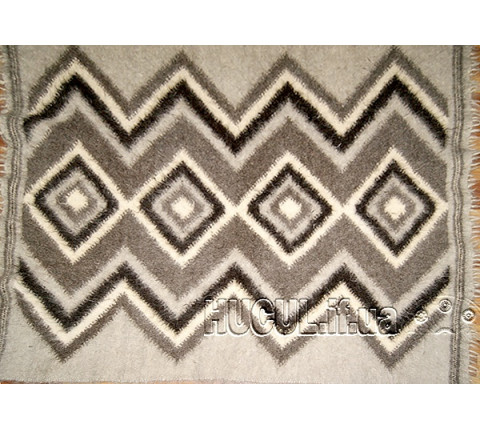 The "Hromovytsia" blanket is black and white, handmade.
