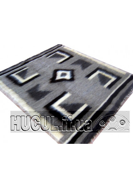 The "Horyany" blanket is black and white, handmade.