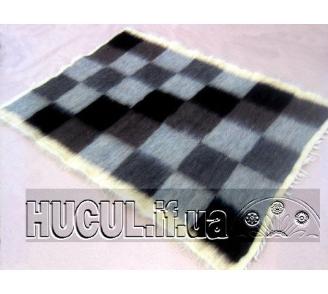 The blanket "In the Meadow" is black and white, handmade.